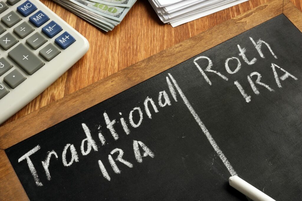 Chalkboard comparing a Traditional IRA and a Roth IRA retirement accounts.