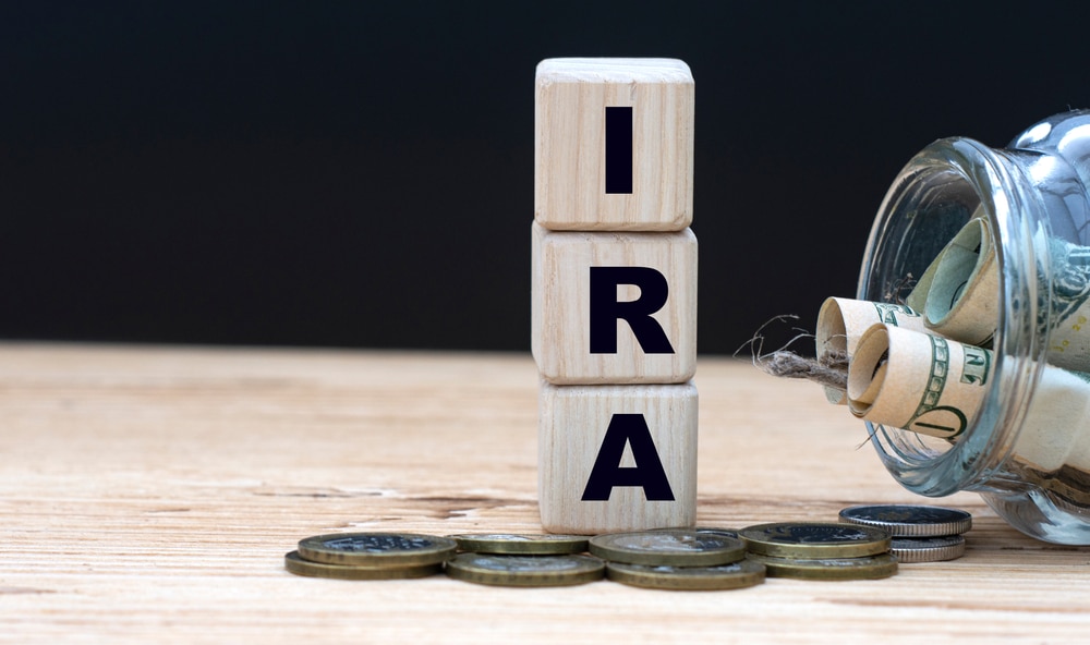 IRA abbreviation on cubes on the background with money