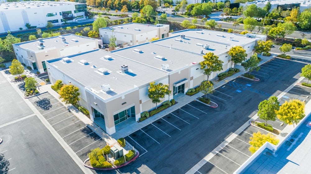 Commercial real estate office building aerial view to show that you can invest in a property with your Self-Directed Checkbook IRA LLC.
