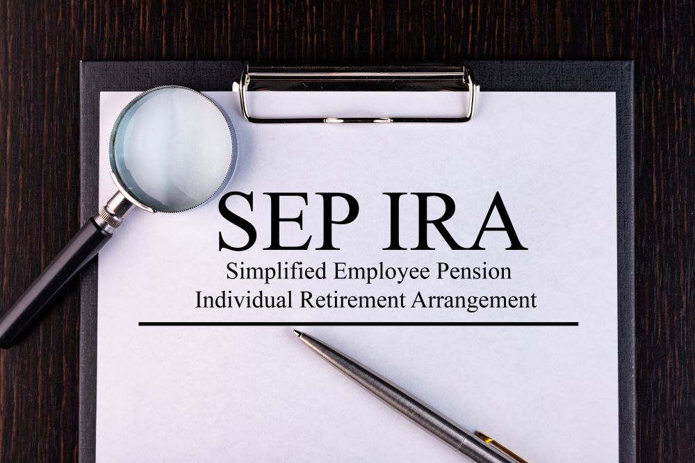 Paper with Simplified Employee Pension Individual Retirement Arrangement SEP IRA on a table